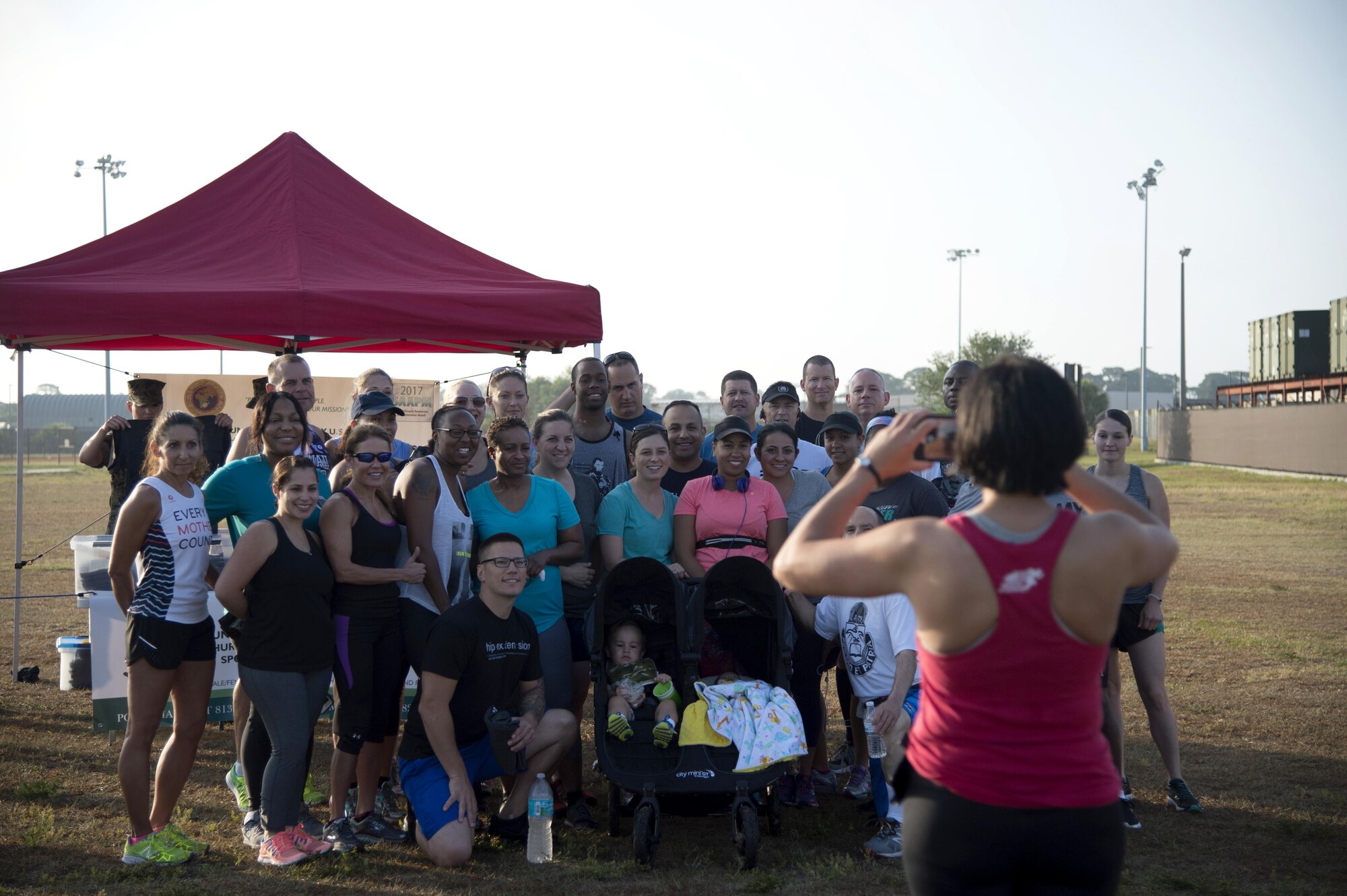 Members of Army Reserve Medical Command, pause for a photo before a sexual assault prevention 5K run April 27, 2017, at MacDill Air Force Base, Fla. Members participated in the run to show their support for the fight against sexual assault and violence. (U.S. Air Force photo by Airman 1st Class Rito Smith) 