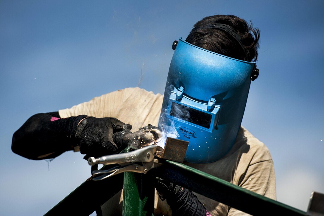 Air Force Airman 1st Class Adrian Wance welds brackets to roof-support beams during Balikatan 2017 in Ormoc City, Philippines, April 27, 2017. Balikatan is an annual U.S.-Philippine military bilateral exercise focused on humanitarian assistance, disaster relief, counterterrorism and other combined military operations. Air Force photo by Staff Sgt. Peter Reft