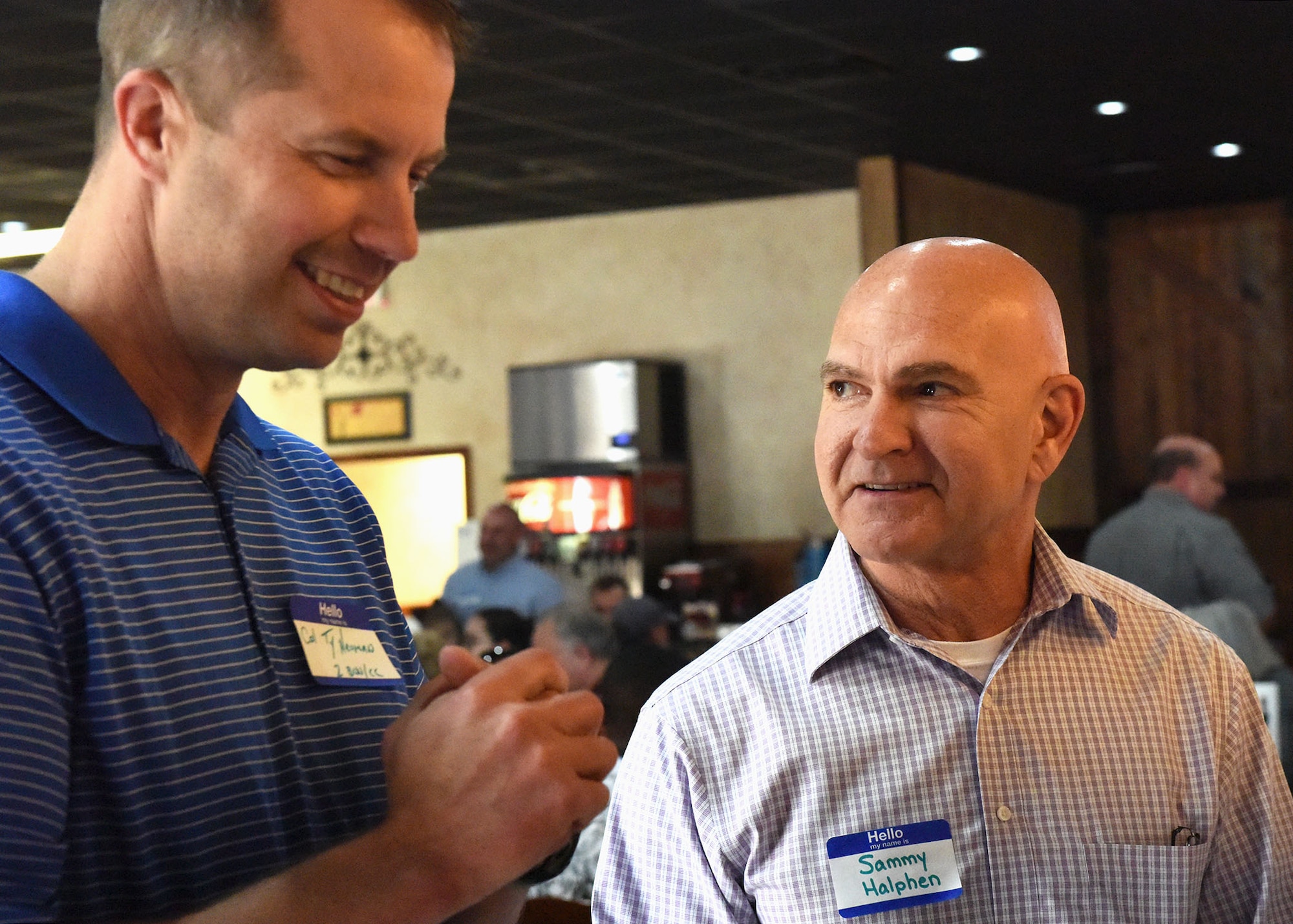 Sammy Halphen, volunteer and host family coordinator for Roots for Boots, speaks with Col. Ty Neuman, 2nd Bomb Wing commander, at the Roots for Boots kickoff event at Shane’s Seafood and BBQ in Bossier City, La., April 30, 2017. Halphen helped match families to their Airmen. (U.S. Air Force Photo/Airman 1st Class Sydney Bennett)