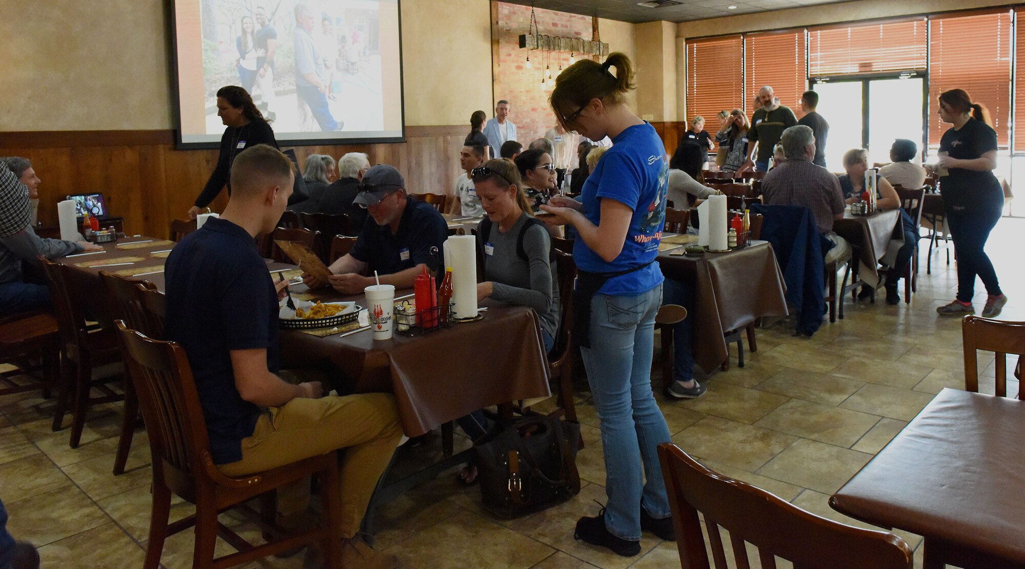 Airmen and their host families at the Roots for Boots kickoff event at Shane’s Seafood and BBQ in Bossier City, La., April 30, 2017. Host families bring Airmen in for holidays and other events when they cannot celebrate with their families back home. (U.S. Air Force Photo/Airman 1st Class Sydney Bennett)