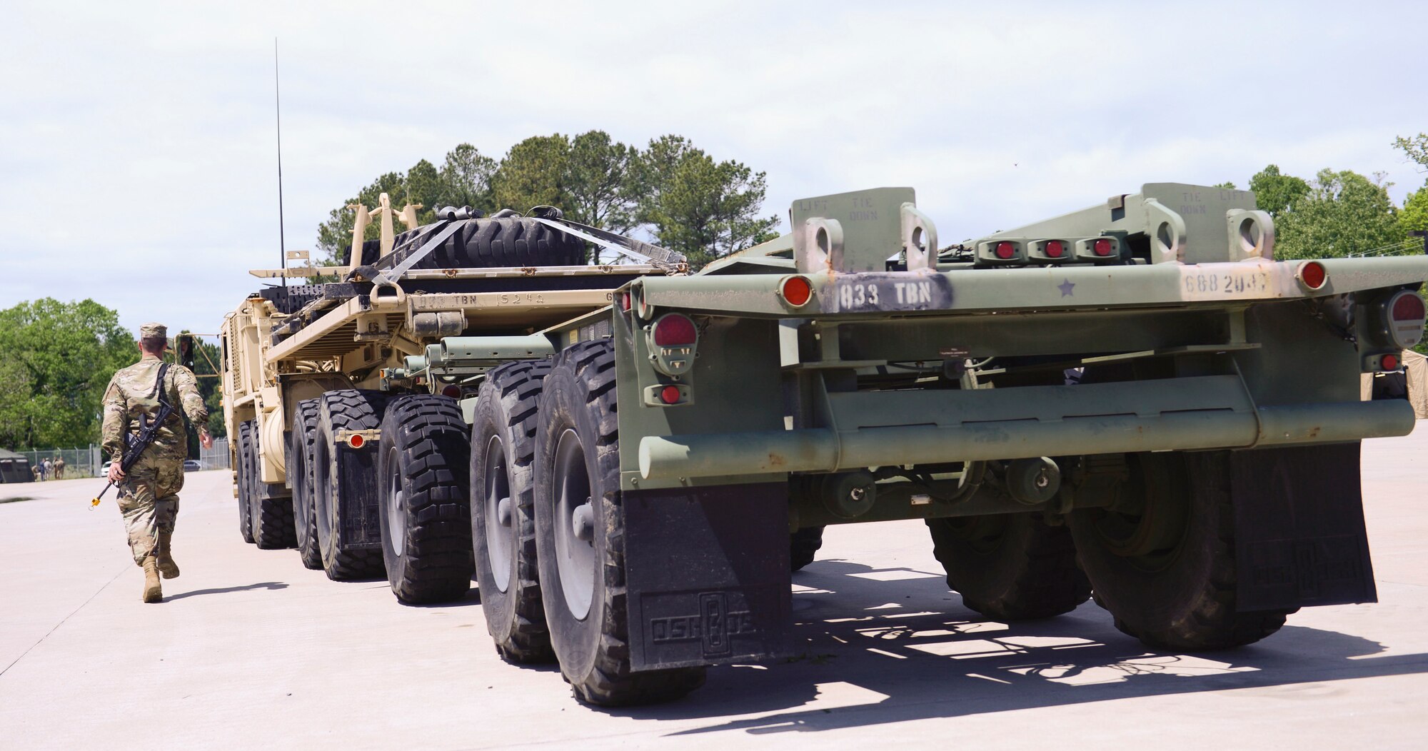 U.S. Army Pvt. Daniel Mitchell, 688th Rapid Port Opening Element motor transport operator, communicates with a vehicle operator to load cargo during an exercise at Joint Base Langley-Eustis, Va., April 26, 2017. Soldiers with the 688th RPOE rapidly deploy to provide the necessary supplies or support in a crisis or contingency operation. (U.S. Air Force photo/Airman 1st Class Kaylee Dubois)