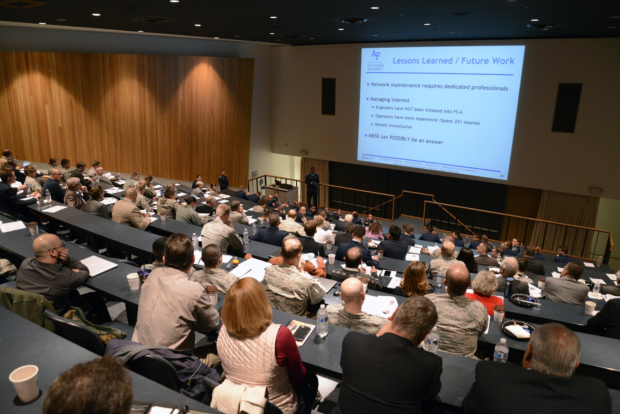 A cadet speaks to an audience of faculty members and industry partners at the FalconSAT End of Semester Review, April 28, 2017, at the U.S. Air Force Academy. (U.S. Air Force photo/Mike Kaplan) 