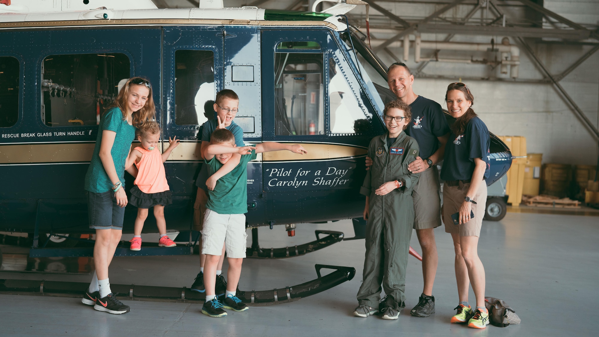 Carolyn Shaffer, Pilot for a Day participant, stands in front of a UH-1N Huey helicopter at Joint Base Andrews, Md., April 28, 2017. To honor and highlight Shaffer’s battle against cancer, JBA teamed up with the Check-6 Foundation, a local non-profit, to make her Pilot for a Day. As part of the program, Shaffer donned a personalized flight suit and flew a UH-1N Iroquois simulator, toured multiple aircraft including an F-16 Fighting Falcon and KC-135 Stratotanker, and participated in a variety of base demonstrations. (U.S. Air Force photo by Senior Airman Delano Scott)