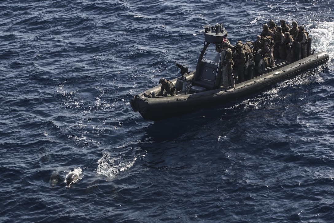 PACIFIC OCEAN, Calif., –  Marines with the 15th Marine Expeditionary Unit, Maritime Raid Force and Sailors with the USS San Diego (LPD-22) are greeted by dolphins before setting off on their vessel board search and seizure mission during PHIBRON-MEU Integration, April 7, 2017. VBSS missions are conducted on hostile vessels to capture high value individuals along with collect intelligence to aid future missions. The 15th MEU undergoes demanding unit-level certification in order to be proficient in rapidly mobilize people and equipment to make the amphibious forces postured to respond to any mission. (U.S. Marine Corps photo by Cpl. Timothy Valero)