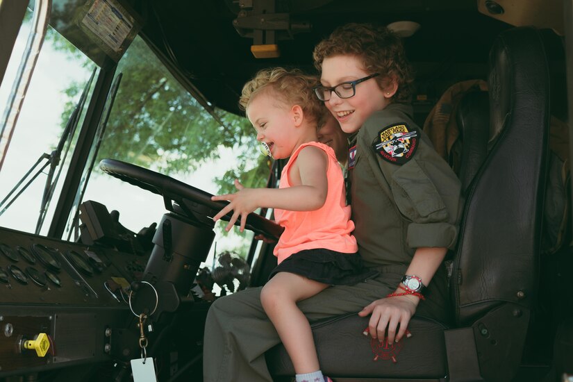 Carolyn Shaffer, right, Pilot for a Day participant, and Brigid Shaffer sit in a 11th Civil Engineer Squadron fire truck at Joint Base Andrews, Md., April 28, 2017. To honor and highlight Shaffer’s battle against cancer, JBA teamed up with the Check-6 Foundation, a local non-profit, to make her Pilot for a Day. As part of the program, Shaffer donned a personalized flight suit and flew a UH-1N Iroquois simulator, toured multiple aircraft including an F-16 Fighting Falcon and KC-135 Stratotanker, and participated in a variety of base demonstrations. (U.S. Air Force photo by Senior Airman Delano Scott)