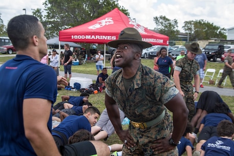 Staff Sergeant David E. Moore, a drill instructor with Recruit Training Regiment, speaks to Future Marines during the Recruiting Station (RS) Fort Lauderdale Annual Pool Function at Marine Corps Reserve Station Hialeah, Hialeah, Florida, Apr. 29, 2017. The annual pool function brought together every recruiting substation within RS Fort Lauderdale for a day of field meet events, friendly competition, and time with Marine Corps drill instructors. The annual function promotes camaraderie while providing Future Marines a sense of what it feels like to be a Marine recruit in the presence of drill instructors. (U.S. Marine Corps photo by Lance Cpl. Jack A. E. Rigsby/Released)