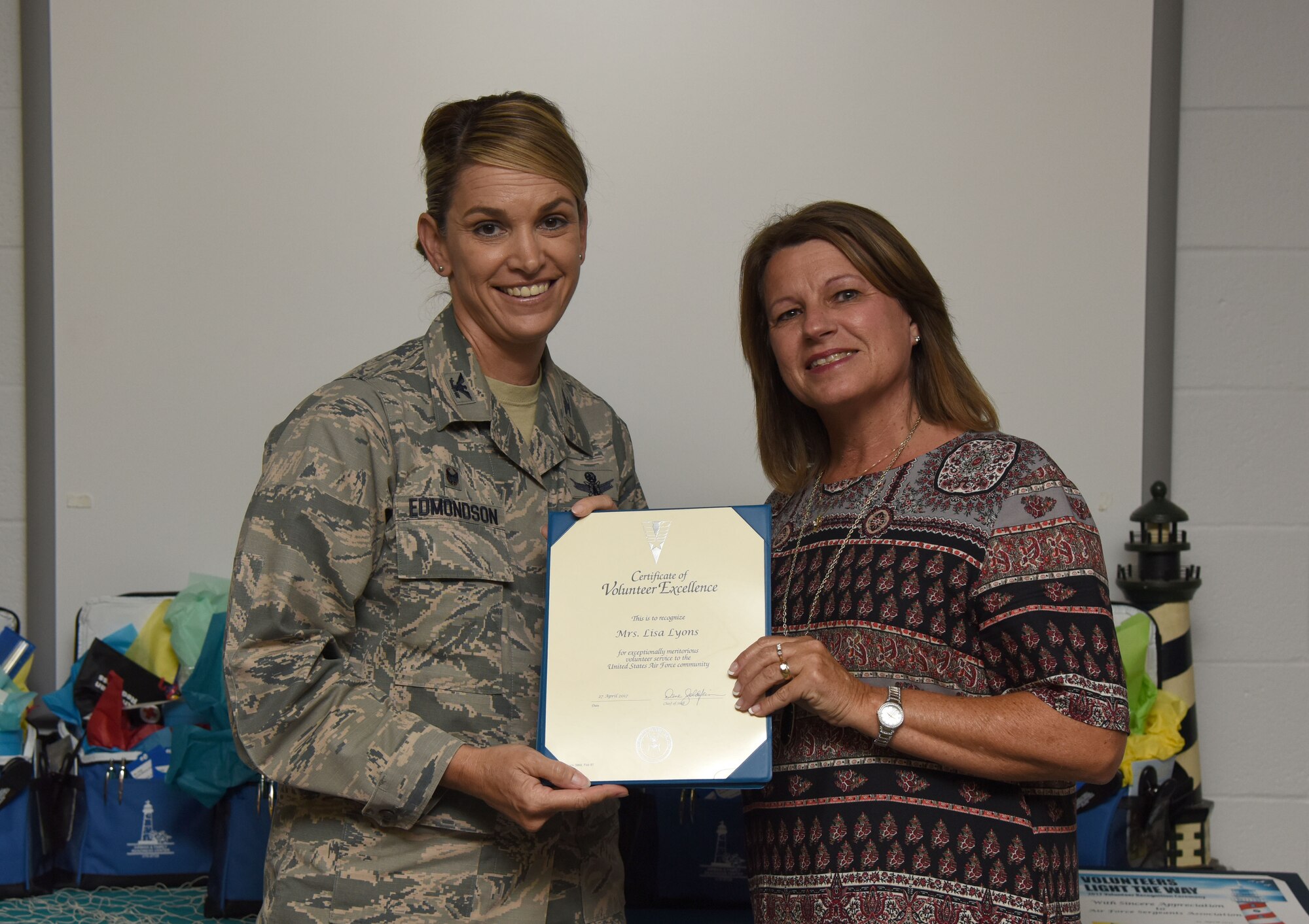 Col. Michele Edmondson, 81st Training Wing commander, presents Lisa Lyons, 81st Force Support Squadron community readiness specialist, with a Volunteer Excellence Award during the Annual Volunteer Recognition Ceremony in the Sablich Center April 27, 2017, on Keesler Air Force Base, Miss. The Volunteer Excellence Award is a lifetime achievement award recognizing volunteerism of a sustained and direct nature. The event recognized Keesler personnel, family member and retiree volunteers for their volunteer service in 2016. (U.S. Air Force photo by Kemberly Groue)