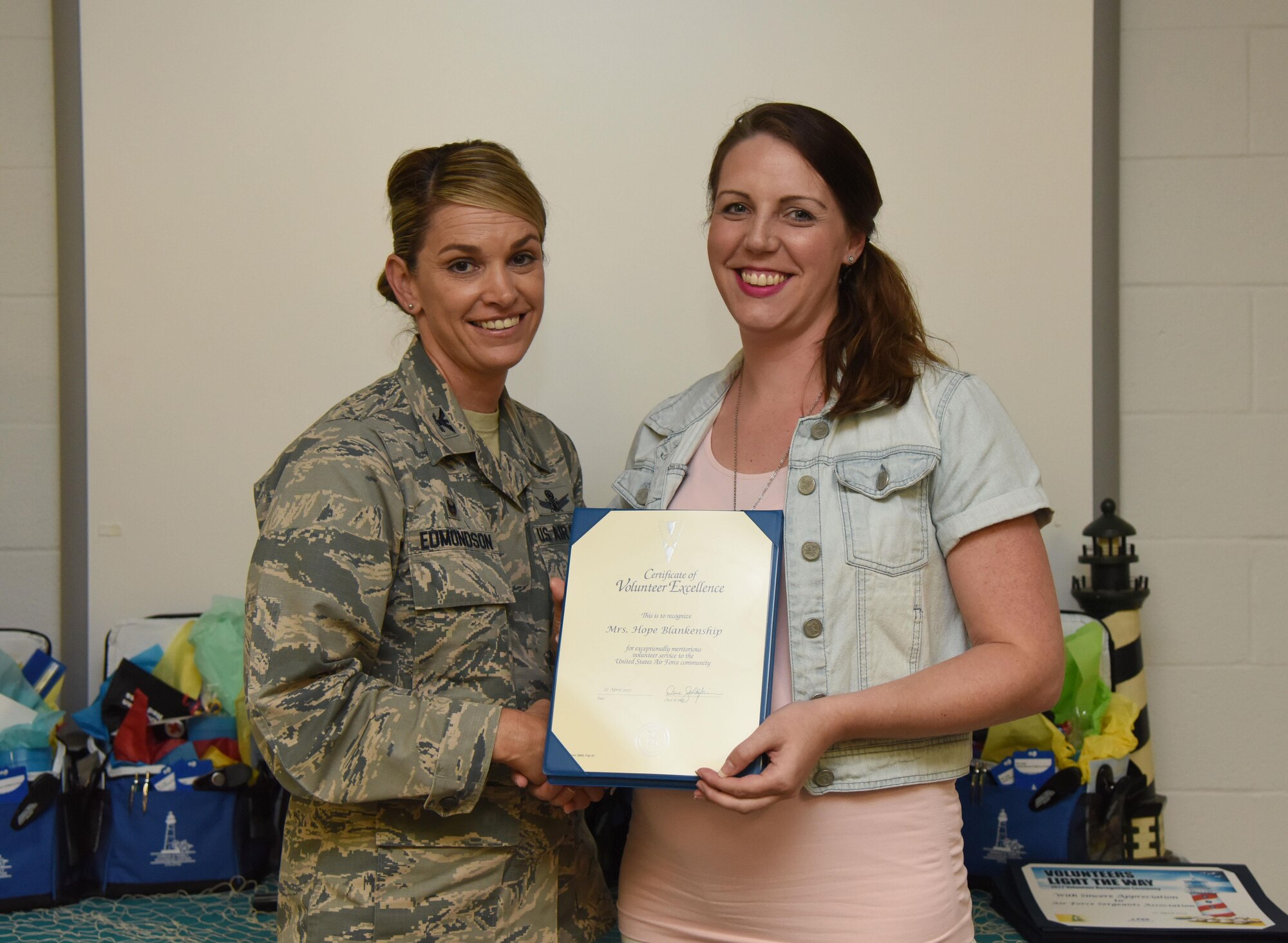 Col. Michele Edmondson, 81st Training Wing commander, presents Hope Blankenship, spouse of Master Sgt. Daniyel Blankenship, 81st Force Support Squadron readiness NCO in charge, with a Volunteer Excellence Award during the Annual Volunteer Recognition Ceremony in the Sablich Center April 27, 2017, on Keesler Air Force Base, Miss. The Volunteer Excellence Award is a lifetime achievement award recognizing volunteerism of a sustained and direct nature. The event recognized Keesler personnel, family member and retiree volunteers for their volunteer service in 2016. (U.S. Air Force photo by Kemberly Groue)