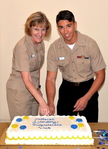 Naval Health Clinic Charleston Commanding Officer Capt. Elizabeth Maley, left, and Seaman Alex Zizzo, a NHCC laboratory technician, cut the cake during a ceremony celebrating Medical Laboratory Professionals Week April 25, 2017 at NHCC.
