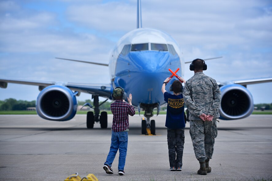 Lt. Col. Ralph "Louie" DePalma's son guides him in during DePalma's "fini" flight April 27, 2017, Scott Air Force Base, Illinois. (U.S. Air Force photo by Christopher Parr)