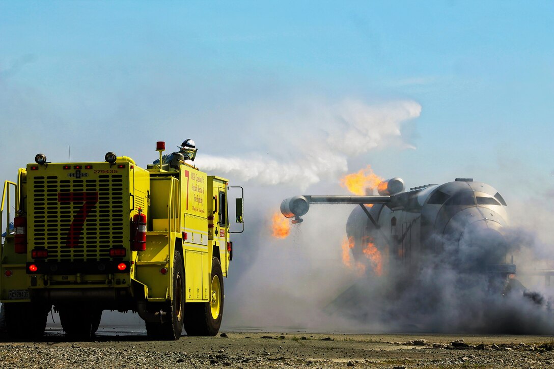 During the Full-Scale Exercise, Marine Corps Air Facility (MCAF) Aircraft Rescue and Fire Fighting (ARFF) responds to the air control tower emergency of a crashed plane.