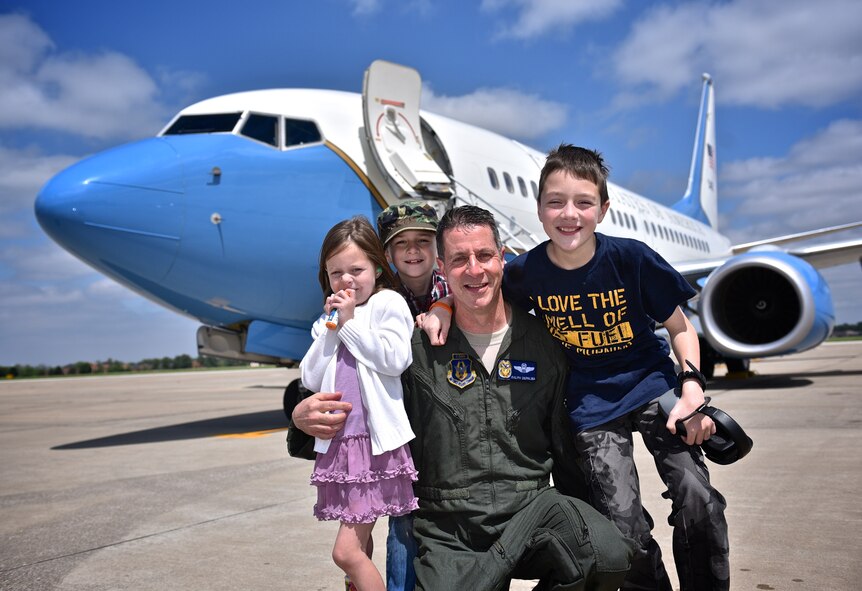Lt. Col. Ralph "Louie" DePalma poses with his children after being soaked during his "fini" flight ceremony April 27, 2017, Scott Air Force Base, Illinois.  DePalma is retiring during the May unit training assembly after serving 30 years with the Air Force.  (U.S. Air Force photo by Christopher Parr)