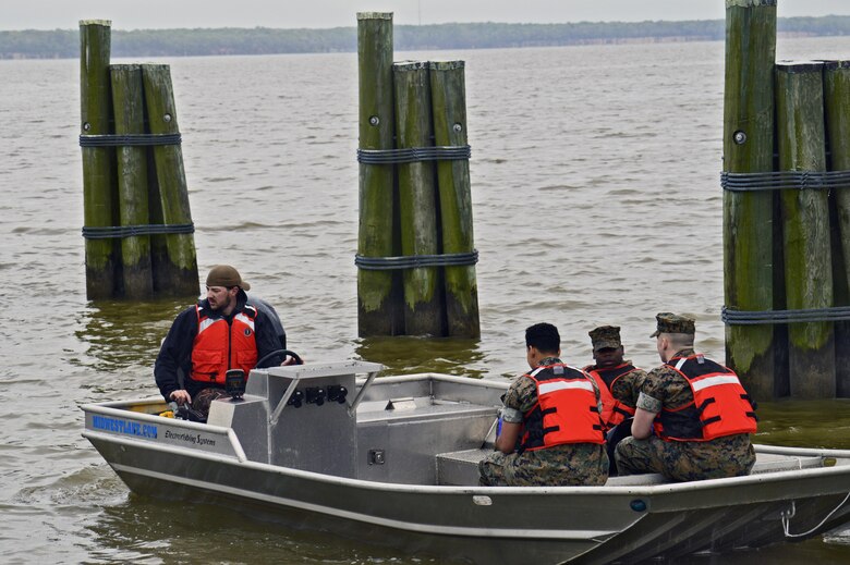 Pfc. Cyrae Aviles, Pfc. Tim Tuite and Pfc. DeMarcus McCullough travel to the far reaches of the Potomac River Shoreline to retreive recycle and trash from usually inexcesible areas.