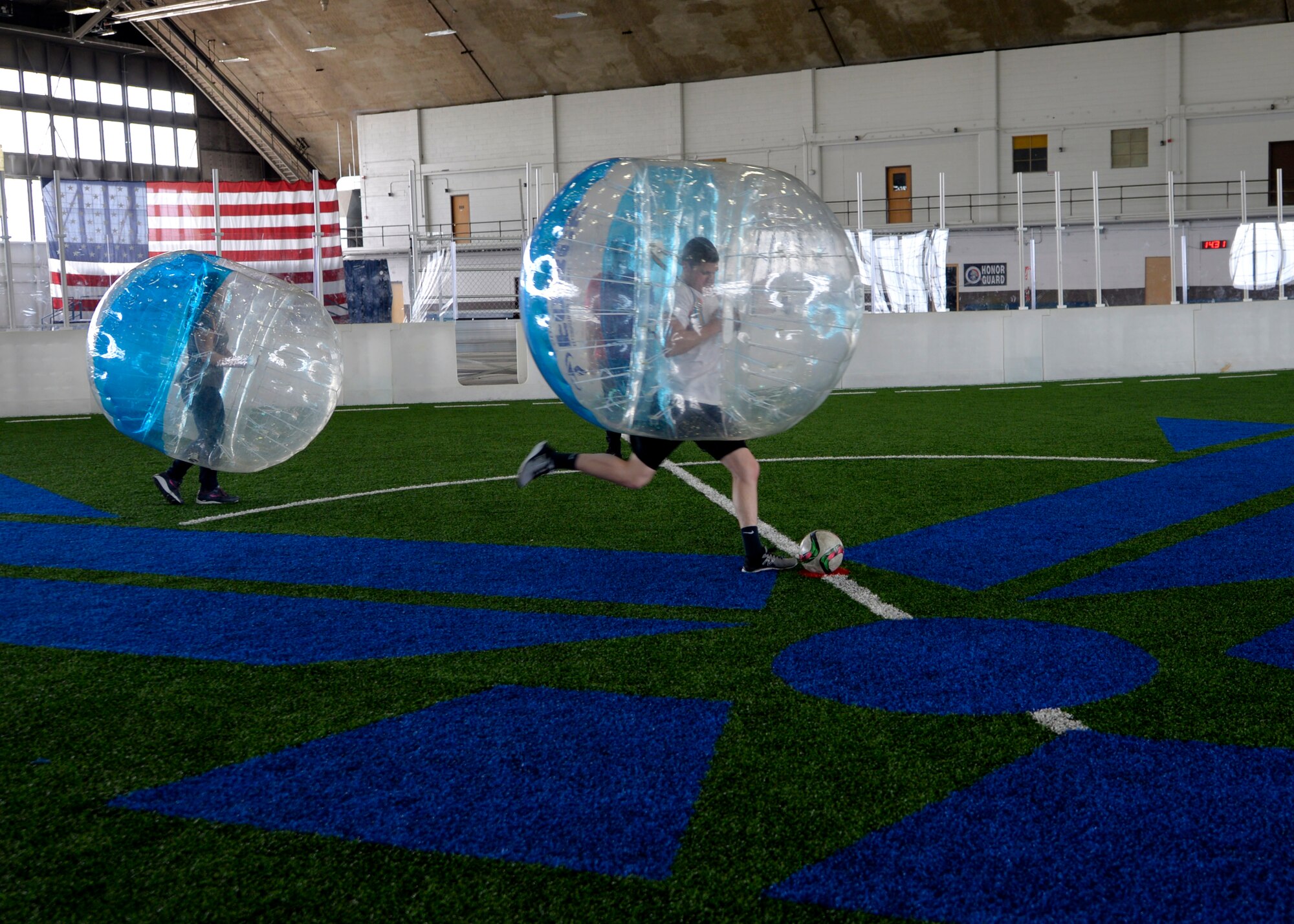 Airmen participate in bubble soccer during a Wingman Day inside the Pride Hangar at Ellsworth Air Force Base, S.D., April 28, 2017. Soccer, basketball, hiking and paintball were a few of the activities that focused on developing Airmen physically and socially. (U.S. Air Force photo by Airman 1st Class Denise Jenson)