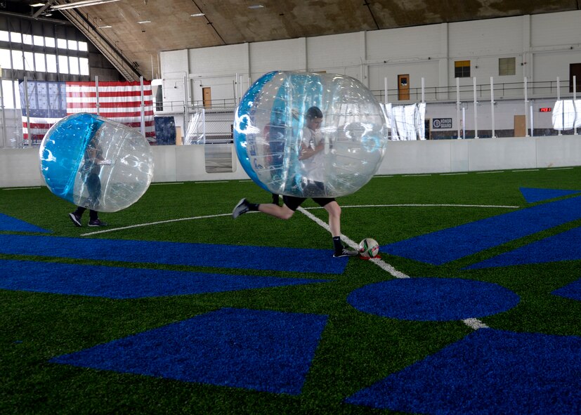 Airmen participate in bubble soccer during a Wingman Day inside the Pride Hangar at Ellsworth Air Force Base, S.D., April 28, 2017. Soccer, basketball, hiking and paintball were a few of the activities that focused on developing Airmen physically and socially. (U.S. Air Force photo by Airman 1st Class Denise Jenson)