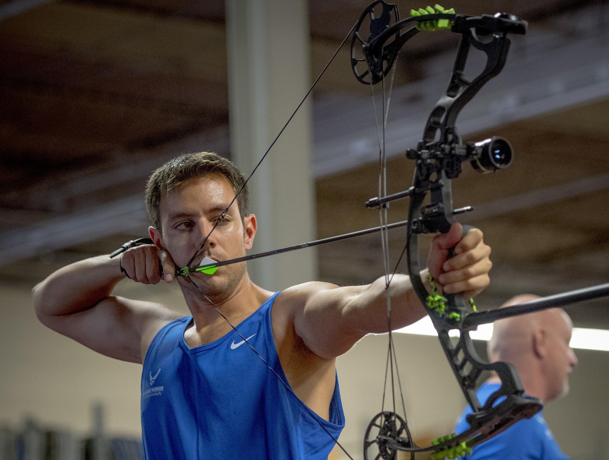 Master Sgt. Kenneth Guinn, 325th Civil Engineer Squadron, aims and holds his arrow at full draw durng an archery session at the Air Force Wounded Warrior adaptive sports camp at Eglin Air Force Base, Fla., April 26. The base hosts the week-long Wounded Warrior CARE event that helps recovering wounded, ill and injured military members through specific hand-on rehabilitative training. (U.S. Air Force photo/Ilka Cole)