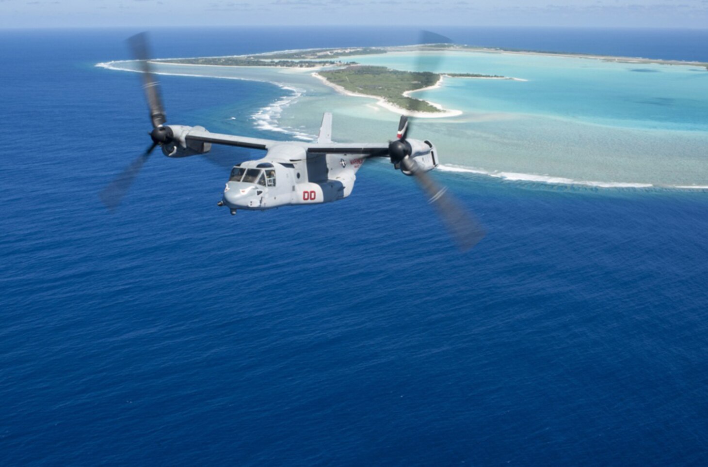 An MV-22B Osprey, assigned to Marine Medium Tiltrotor Squadron (VMM) 163 (Reinforced), embarked aboard the amphibious assault ship USS Makin Island (LHD 8), flies past Wake Island, April 24, 2017. Makin Island, the flagship for the Makin Island Amphibious Ready Group, with the embarked 11th Marine Expeditionary Unit, is operating in the Pacific Ocean to enhance amphibious capability with regional partners and to serve as a ready-response force for any type of contingency. 