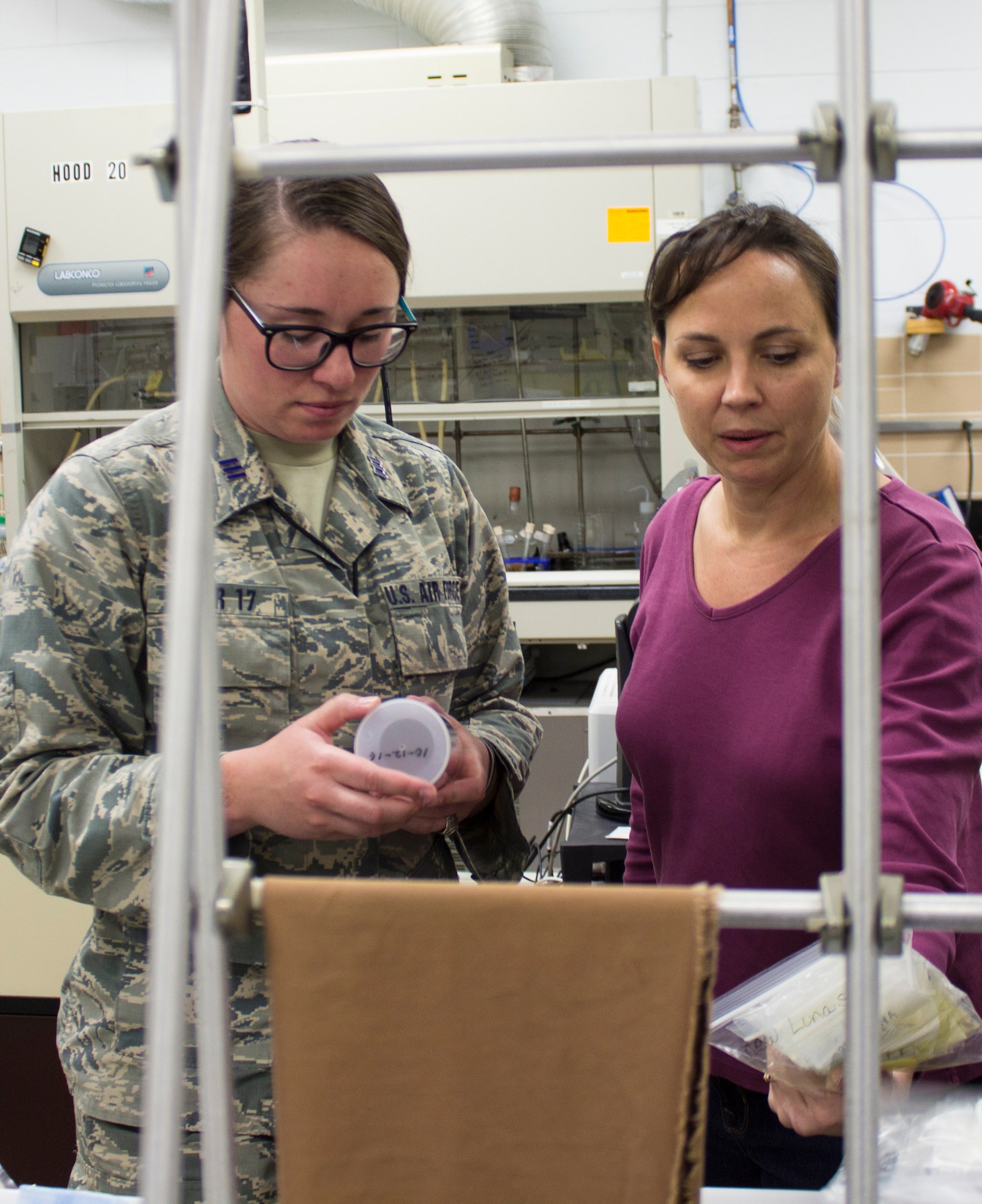 From left, U.S. Air Force Academy Cadet First Class Hayley Weir and AFCEC research chemist Katherine Simpson talk about Weir's capstone project; the development of a new ballistic resistant, flexible, lightweight nanotech-enabled fabric. The material, which is patent pending, could be applied as a protective lining on a variety of objects ranging from body armor to tents and vehicles. (U.S. Air Force photo/Mekka Parish)