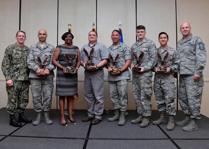 Members of Team Charleston are recognized by U.S. Navy Capt. Robert Hudson, left, Joint Base Charleston deputy commander, and Command Chief Master Sgt. Todd Cole, right, 628th Air Base Wing command chief, during the 628th ABW First-Quarter Awards Ceremony at the Charleston Club May 2, 2017, at Joint Base Charleston, S.C. Award winners were selected based on their ability to perform primary duties while adapting to military requirements.