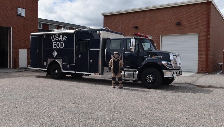 Staff Sgt. Adam Hickman, 90th Civil Engineer Squadron, explosive ordnance disposal craftsman, poses in bomb suit near the emergency response vehicle, at F.E. Warren Air Force Base, Wyo., April 28, 2017. (U.S. Air Force photo by Terry Higgins) 