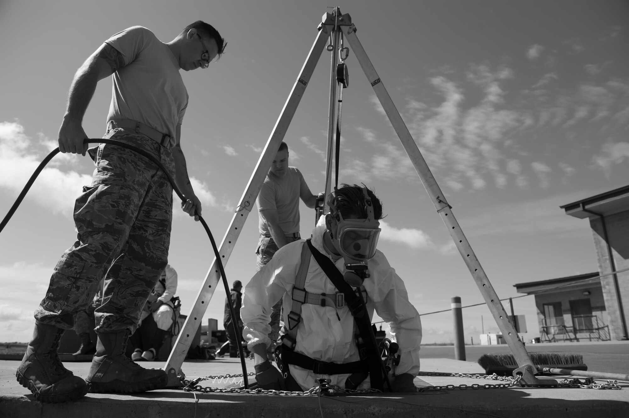 Senior Airman Christopher Lemming, 9th Civil Engineer Squadron water and fuels systems maintenance, descends into an underground water tank during a training exercise at Beale Air Force Base, California, April 27, 2017. During confined space entry, every team member plays a specific role from an attendant to oxygen monitor, which helps ensure efficient entry of the confined space. (U.S. Air Force photo by Airman 1st Class Justin Parsons/Released)