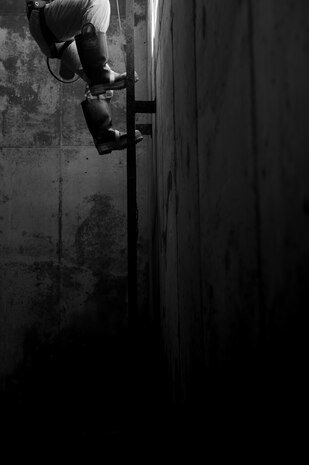 Staff Sgt Joshua Manske, 9th Civil Engineer Squadron water and fuels maintenance, climbs up ladder to exit the underground tank once he has finished his iteration of confined space entry training at Beale Air Force Base, California, April 27, 2017. Members of a confined space entry team will run through practice iterations multiple times a year to stay proficient. (U.S. Air Force photo by Airman 1st Class Justin Parsons/Released)