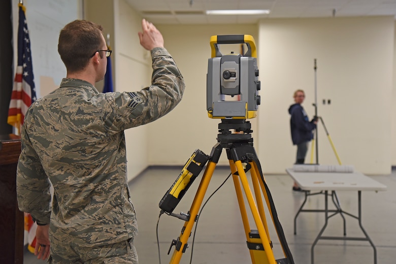 Senior Airman Jacob Costello, 92nd Civil Engineer Squadron engineering assistant, demonstrates using various pieces of surveying equipment during a Science, Technology, Engineering and Math tour May 1, 2017, at Fairchild Air Force Base, Washington. The students were exposed to numerous forms of engineering including civil, geotechnical, structural, environmental and mechanical. (U.S. Air Force photo/Senior Airman Mackenzie Richardson)