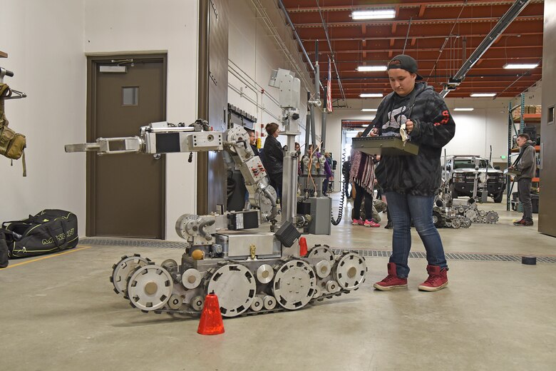 Paideia High School students receive a hands-on demonstration of the various robots used by the 92nd Civil Engineer Squadron explosive ordinance disposal during a tour May 1, 2017, at Fairchild Air Force Base, Washington. The tour focused on Science, Technology, Engineering and Math and provided students the opportunity to visualize engineering and math used in careers. (U.S. Air Force photo/Senior Airman Mackenzie Richardson)