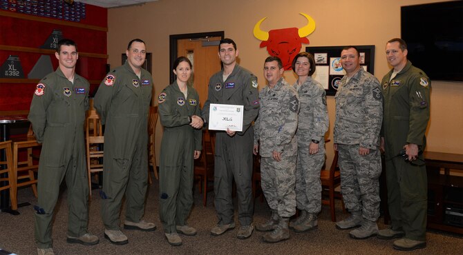 1st Lt. Jonathan Graziano, 87th Flying Training Squadron assistant flight commander (center), accepts the “XLer of the Week” award from Col. Michelle Pryor, 47th Flying Training Wing vice commander (left), and Chief Master Sgt. George Richey, 47th FTW command chief (right), on Laughlin Air Force Base, Texas, April 26, 2017. The XLer is a weekly award chosen by wing leadership and is presented to those who consistently make outstanding contributions to their unit and Laughlin. (U.S. Air Force photo/Airman 1st Class Daniel Hambor)