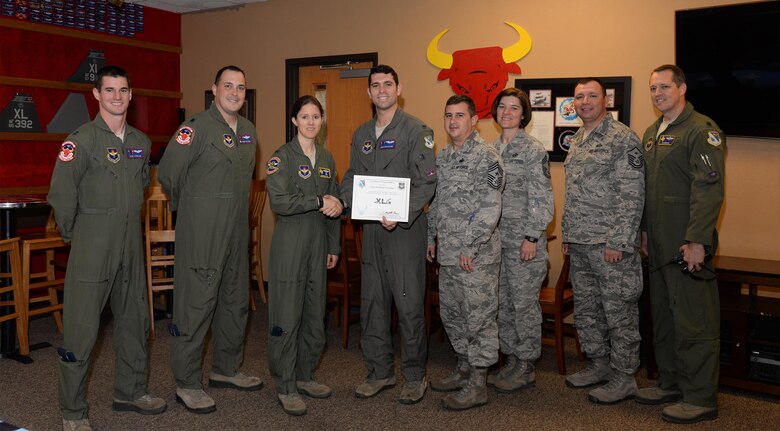 1st Lt. Jonathan Graziano, 87th Flying Training Squadron assistant flight commander (center), accepts the “XLer of the Week” award from Col. Michelle Pryor, 47th Flying Training Wing vice commander (left), and Chief Master Sgt. George Richey, 47th FTW command chief (right), on Laughlin Air Force Base, Texas, April 26, 2017. The XLer is a weekly award chosen by wing leadership and is presented to those who consistently make outstanding contributions to their unit and Laughlin. (U.S. Air Force photo/Airman 1st Class Daniel Hambor)
