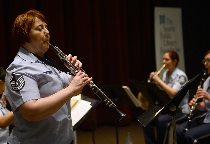 Master Sgt. Coreen Levin (center), Golden West Winds NCO in charge and oboe player, plays a song during the Golden West Winds performance at the Seattle Public Library, May 1, 2017 in Seattle, Wash. The members of the Golden West Winds are all professional Air force musicians working in support of Air Force and Air Mobility Command official military recruiting and community relations objectives. (U.S. Air Force photo/Senior Airman Divine Cox)
 
