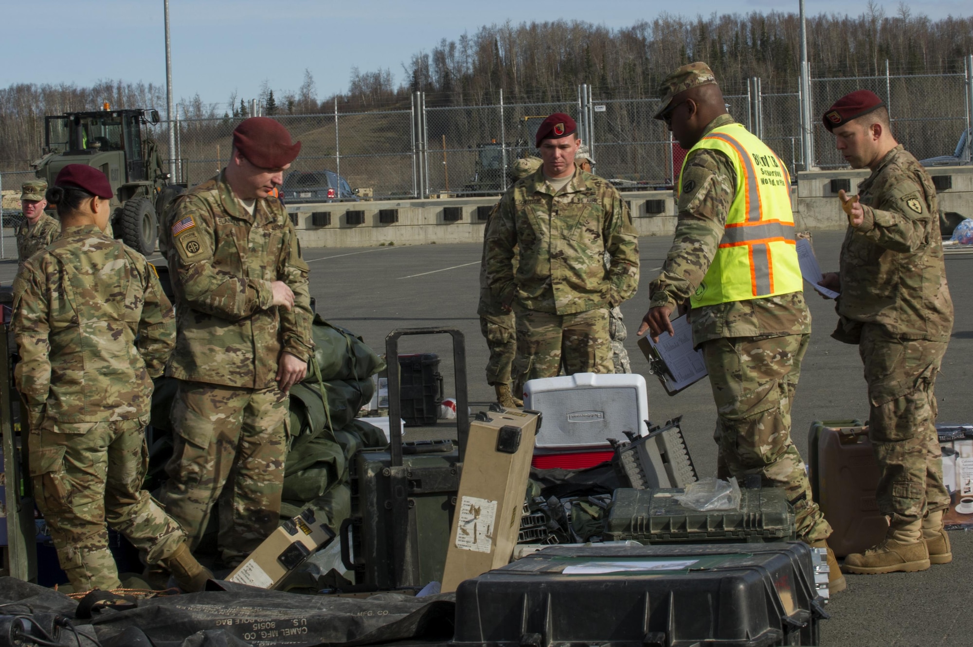 Army Staff Sgt. Luis Ramos instruct Soldiers to remove undeclared hazard materials after inspecting a small cargo at the Movement Control Center, Joint Base Elmendorf-Richardson, Alaska, May 2, 2017. The MCC transports mission-critical cargo for the 4th Brigade Combat Team (Airborne), 25th Infantry Division, who will be participating at the Joint Readiness Training Center at Folk Polk, Louisianna. The JRTC is the Army's premier training center for light infantry and special operations unit. Ramos is assigned to the 842nd Transportation Battalion, 597th Transportation Brigade, Beaumont, Texas. (U.S. Air Force photo by Staff Sgt. Sheila deVera)