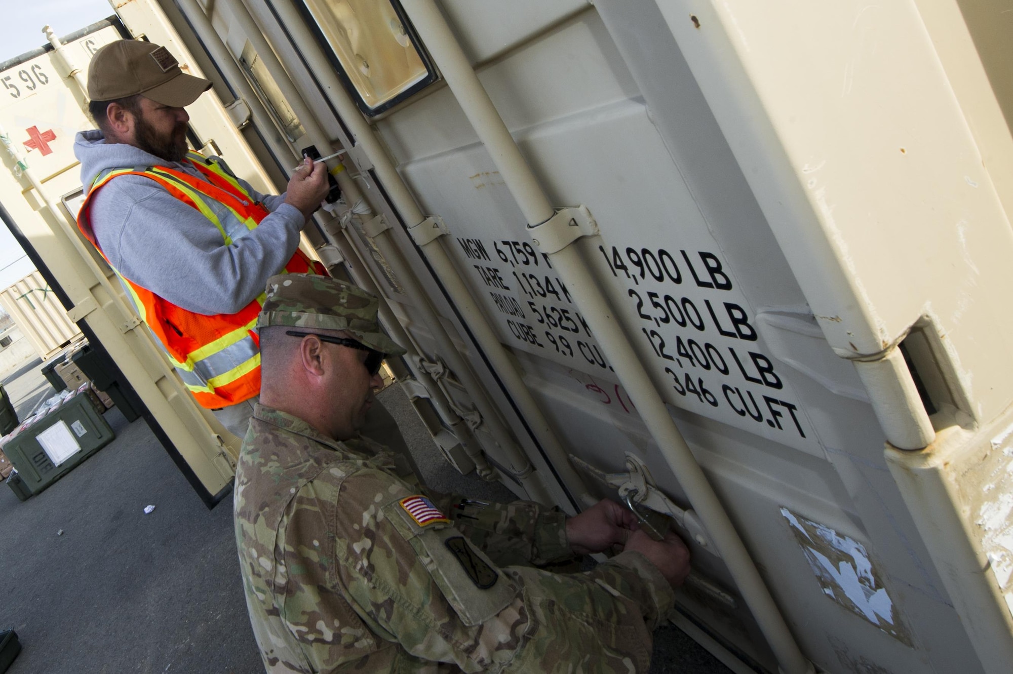 Todd Evilsizer, 773d Logistics Readiness Squadron deployment specialist, and Army Staff Sgt. Bradley Winglet, 486th Movement Control Team, 17th Combat Sustainment Support Battalion, secure a container before it is transported to its final destination at the Movement Control Center, Joint Base Elmendorf-Richardson, Alaska, May 2, 2017. (U.S. Air Force photo by Staff Sgt. Sheila deVera)
