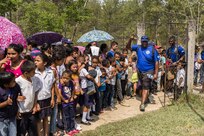 Villagers of San Jerónimo, Comayagua, Honduras wait for more than 190 members of Joint Task Force-Bravo to hiked approximately 3.6 miles round-trip to the village, Apr. 29, 2017. Members carried more than 5025 lbs of food and supplies, 24 soccer balls and 3 piñatas to the people of San Jerónimo. Chapel hikes have been occurring since 2003, with the JTF-Bravo Chapel sponsoring an average of six every year. The hikes are designed to provide a practical way for JTF-Bravo members to engage and partner with local communities to provide support to surrounding villages in need of food and supplies. (U.S. Air National Guard photo by Master Sgt. Scott Thompson/released)