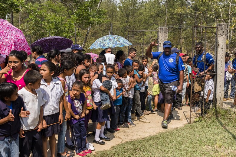 Villagers of San Jerónimo, Comayagua, Honduras wait for more than 190 members of Joint Task Force-Bravo to hiked approximately 3.6 miles round-trip to the village, Apr. 29, 2017. Members carried more than 5025 lbs of food and supplies, 24 soccer balls and 3 piñatas to the people of San Jerónimo. Chapel hikes have been occurring since 2003, with the JTF-Bravo Chapel sponsoring an average of six every year. The hikes are designed to provide a practical way for JTF-Bravo members to engage and partner with local communities to provide support to surrounding villages in need of food and supplies. (U.S. Air National Guard photo by Master Sgt. Scott Thompson/released)