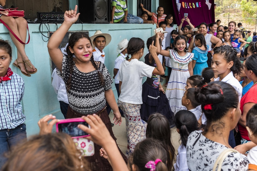 School children from San Jerónimo, Comayagua, Honduras show traditional Honduran dances to more than 190 members of Joint Task Force-Bravo who hiked approximately 3.6 miles round-trip to the village, Apr. 29, 2017. Members carried more than 5025 lbs of food and supplies, 24 soccer balls and 3 piñatas to the people of San Jerónimo. Chapel hikes have been occurring since 2003, with the JTF-Bravo Chapel sponsoring an average of six every year. The hikes are designed to provide a practical way for JTF-Bravo members to engage and partner with local communities to provide support to surrounding villages in need of food and supplies. (U.S. Air National Guard photo by Master Sgt. Scott Thompson/released)