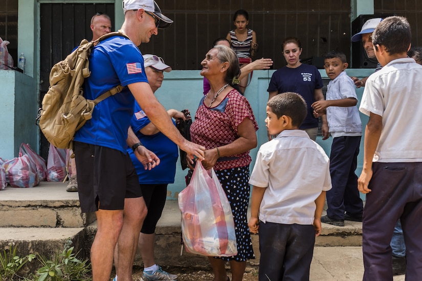 Villagers of San Jerónimo, Comayagua, Honduras receive bags of food from more than 190 members of Joint Task Force-Bravo to hiked approximately 3.6 miles round-trip to the village, Apr. 29, 2017. Members carried more than 5025 lbs of food and supplies, 24 soccer balls and 3 piñatas to the people of San Jerónimo. Chapel hikes have been occurring since 2003, with the JTF-Bravo Chapel sponsoring an average of six every year. The hikes are designed to provide a practical way for JTF-Bravo members to engage and partner with local communities to provide support to surrounding villages in need of food and supplies. (U.S. Air National Guard photo by Master Sgt. Scott Thompson/released)