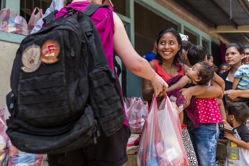 Villagers of San Jerónimo, Comayagua, Honduras receive bags of food from more than 190 members of Joint Task Force-Bravo who hiked approximately 3.6 miles round-trip to the village, Apr. 29, 2017. Members carried more than 5025 lbs of food and supplies, 24 soccer balls and 3 piñatas to the people of San Jerónimo. Chapel hikes have been occurring since 2003, with the JTF-Bravo Chapel sponsoring an average of six every year. The hikes are designed to provide a way for JTF-Bravo members to engage and partner with local communities and provide support to surrounding villages in need of food and supplies. (U.S. Air National Guard photo by Master Sgt. Scott Thompson/released)