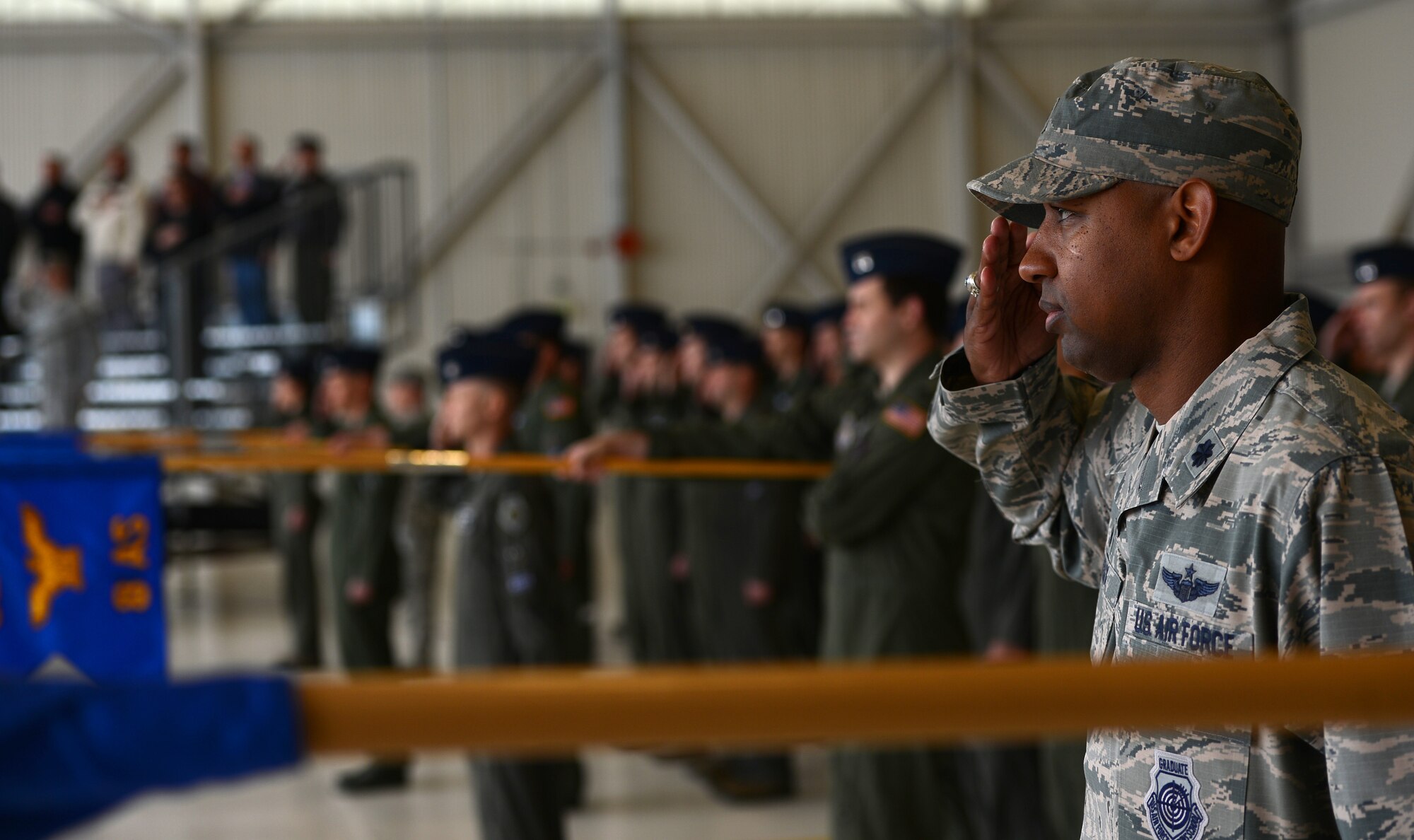 Lt. Col. Jaron Roux, 62nd Operations Support Squadron commander, salutes the U.S. flag during the national anthem at the 62nd Operations Group change of command ceremony May 1, 2017, at Joint Base Lewis-McChord, Wash. The incoming commander, Col. Mark Fuhrmann, not his first time at McChord, was previously assigned to the 7th Airlift Squadron flying the C-141B Starlifter and C-17 Globemaster III aircraft in the early 2000’s. (U.S. Air Force photo/Senior Airman Jacob Jimenez) 