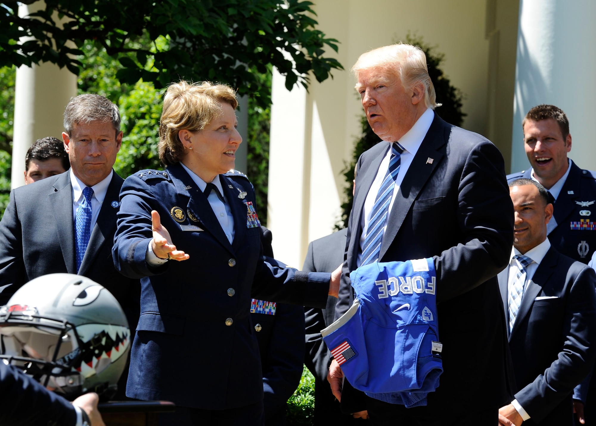 Lt. Gen. Michelle D. Johnson, the superintendent of the U.S. Air Force Academy, presents President Donald Trump with a team helmet at the White House May 2, 2017. Trump presented the team the Commander in Chief's Trophy, with Acting Secretary of the Air Force Lisa S. Disbrow and Air Force Chief of Staff Gen. David L. Goldfein present for the ceremony. (U.S. Air Force photo/Staff Sgt. Jannelle McRae)