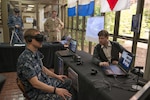 BANGOR, Wash. (April 27, 2017) Sonar Technician 2nd Class Andrew McFarland, assigned to Trident Training Facility (TTF) Bangor, tests the OceanLens, which uses an Oculus Rift virtual reality headset to create a 3D immersive environment for visualizing undersea topography, during the Innovation Lab (iLab) roadshow held at Trident Training Facility Bangor. The iLab, which is located at Naval Submarine Training Center Pacific, in Pearl Harbor, Hawaii, is an initiative launched to spur the rapid development of ideas and concepts to actionable use in submarine warfare. (U.S. Navy photo by Mass Communication Specialist 1st Class Amanda R. Gray/Released)