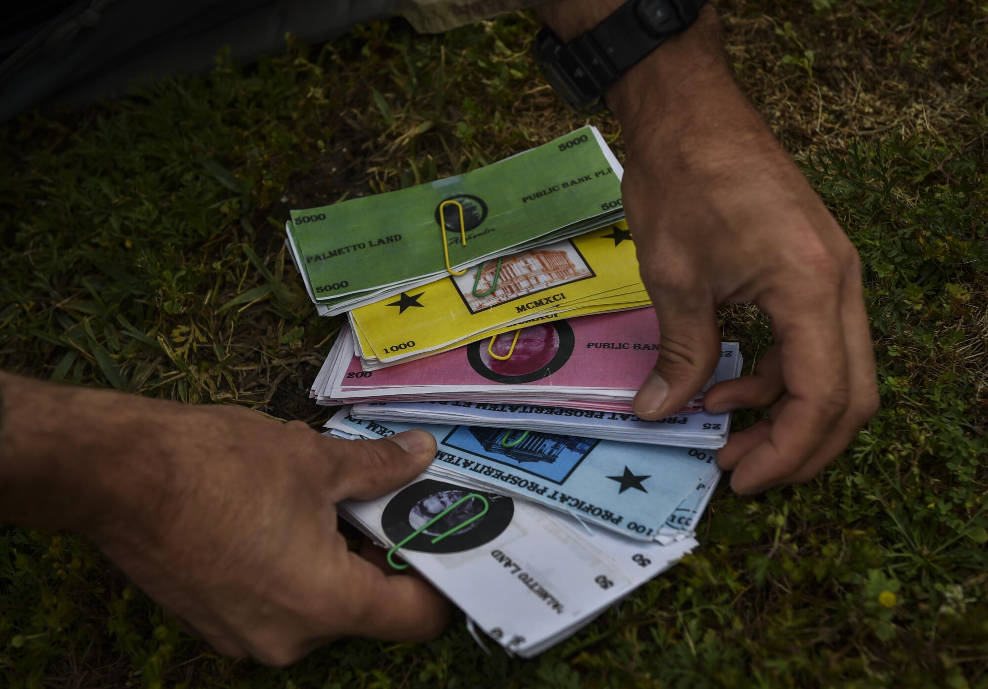 A 6th Special Operations Squadron combat aviation advisor student sorts “Palmetto Land” money during Operation Raven Claw at Hurlburt Field, Fla., April 24, 2017. Students traveled to “Palmetto Land,” a simulated indigenous country, where they were tasked to train and assist the "Palmetto Land" forces in enhancing the tactical employment of its aircraft and soldiers. (U.S. Air Force photo by Airman 1st Class Joseph Pick)