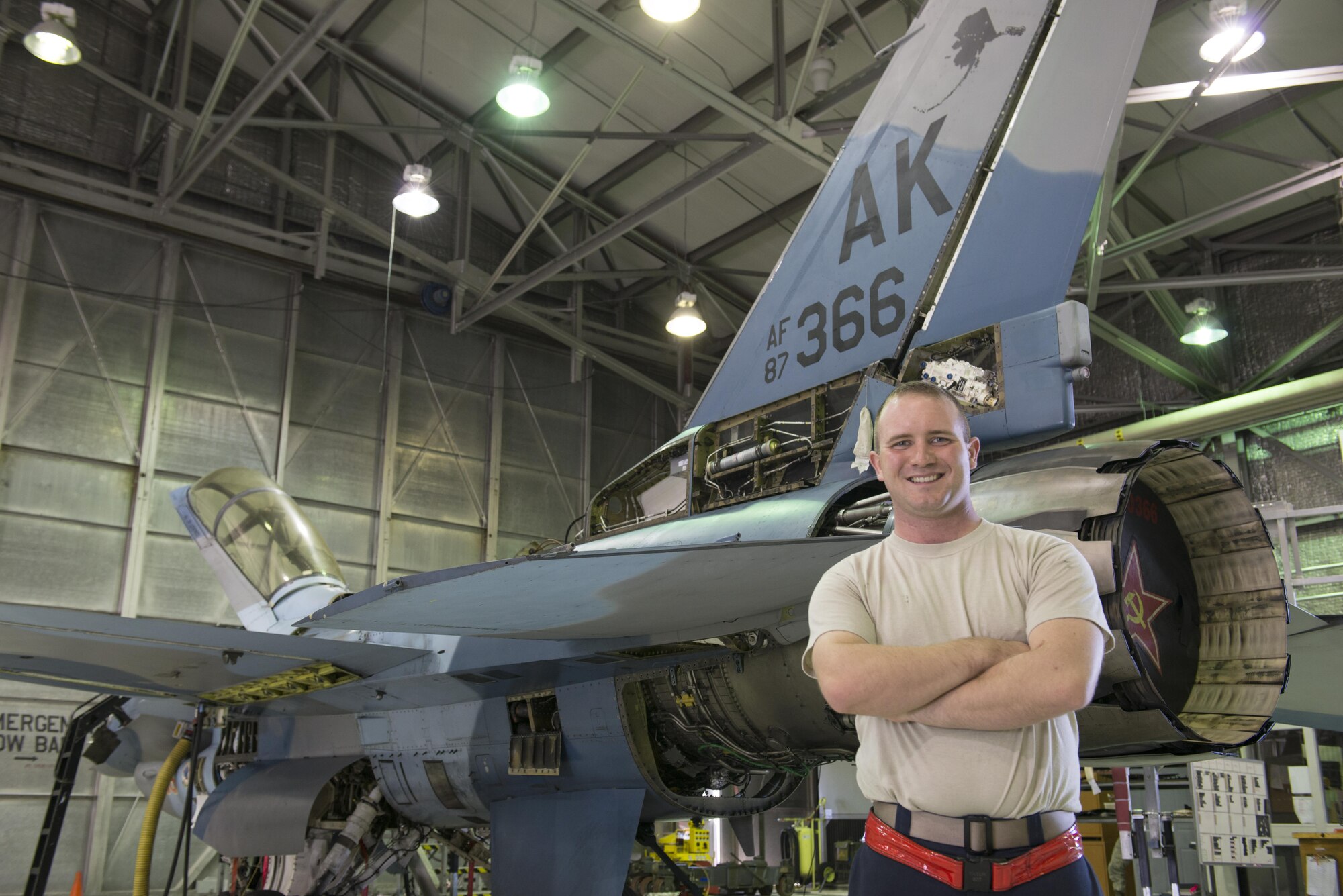 EIELSON AIR FORCE BASE, Alaska – U.S. Air Force Senior Airman Michael “Tater” Brinkmeyer, a 354th Aircraft Maintenance Squadron crew chief, poses for a photo in front of an F-16 Fighting Falcon from the 18th Aggressor Squadron during NORTHERN EDGE 2017 (NE17), May 2, 2017, at Eielson Air Force Base, Alaska. NE17 is Alaska’s premier joint training exercise designed to practice operations, techniques and procedures as well as enhance interoperability among the services. Thousands of participants from all the services, Airmen, Soldiers, Sailors, Marines and Coast Guardsmen from active duty, Reserve and National Guard units are involved. (U.S. Air Force photo/Staff Sgt. Ashley Nicole Taylor)