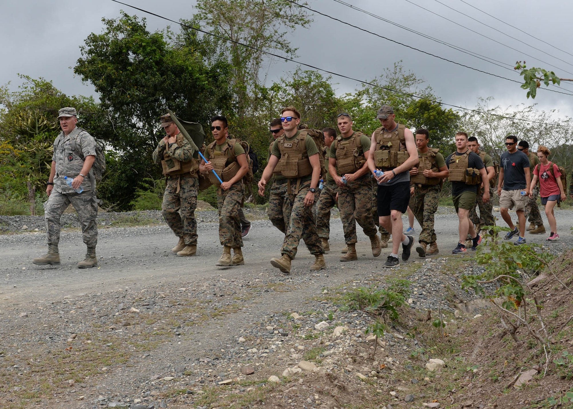 U.S. Air Force Col. Michael Weymeyer, the 346th Air Expeditionary Group commander, leads a group of U.S. service members on a march uphill while participating in the Sexual Assault Prevention and Response 5K Ruck March in Arroyo Cano, Dominican Republic, April 9, 2017. Both men and women can be victims of sexual assault, and there are support services and reporting options available for all victims, regardless of their situation. (U.S. Air Force photo by Staff Sgt. Timothy M. Young)