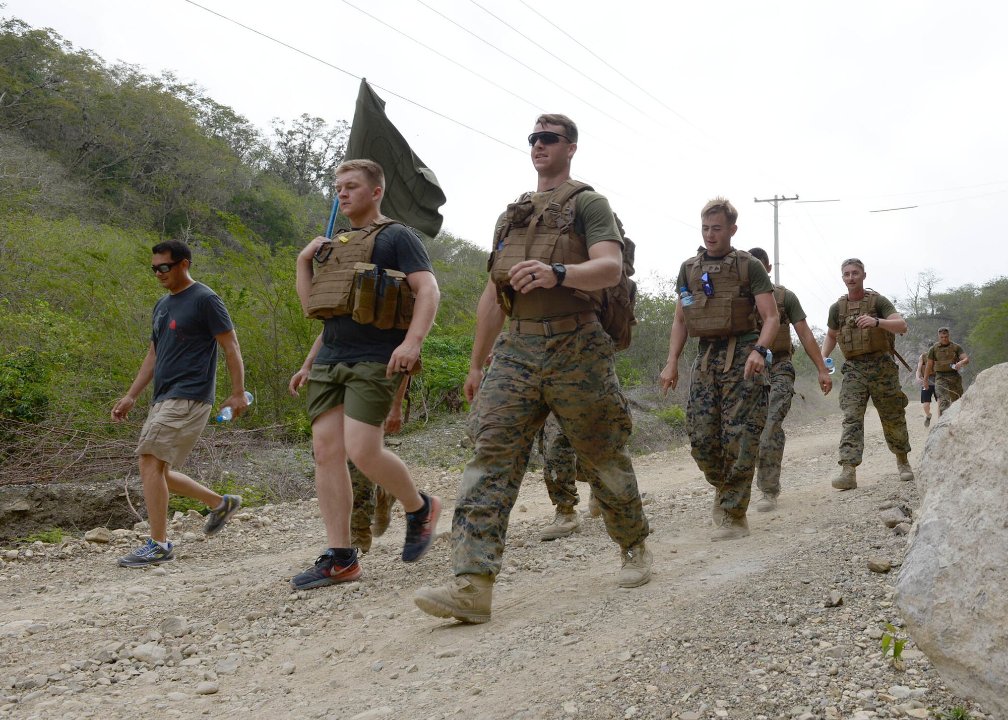 A group of U.S. service members march downhill while participating in a Sexual Assault Prevention and Response 5K Ruck March in Arroyo Cano, Dominican Republic, April 9, 2017. Together, all service members must work every day to instill and maintain a climate that does not tolerate or ignore sexist behavior, sexual harassment, or sexual assault. (U.S. Air Force photo by Staff Sgt. Timothy M. Young)