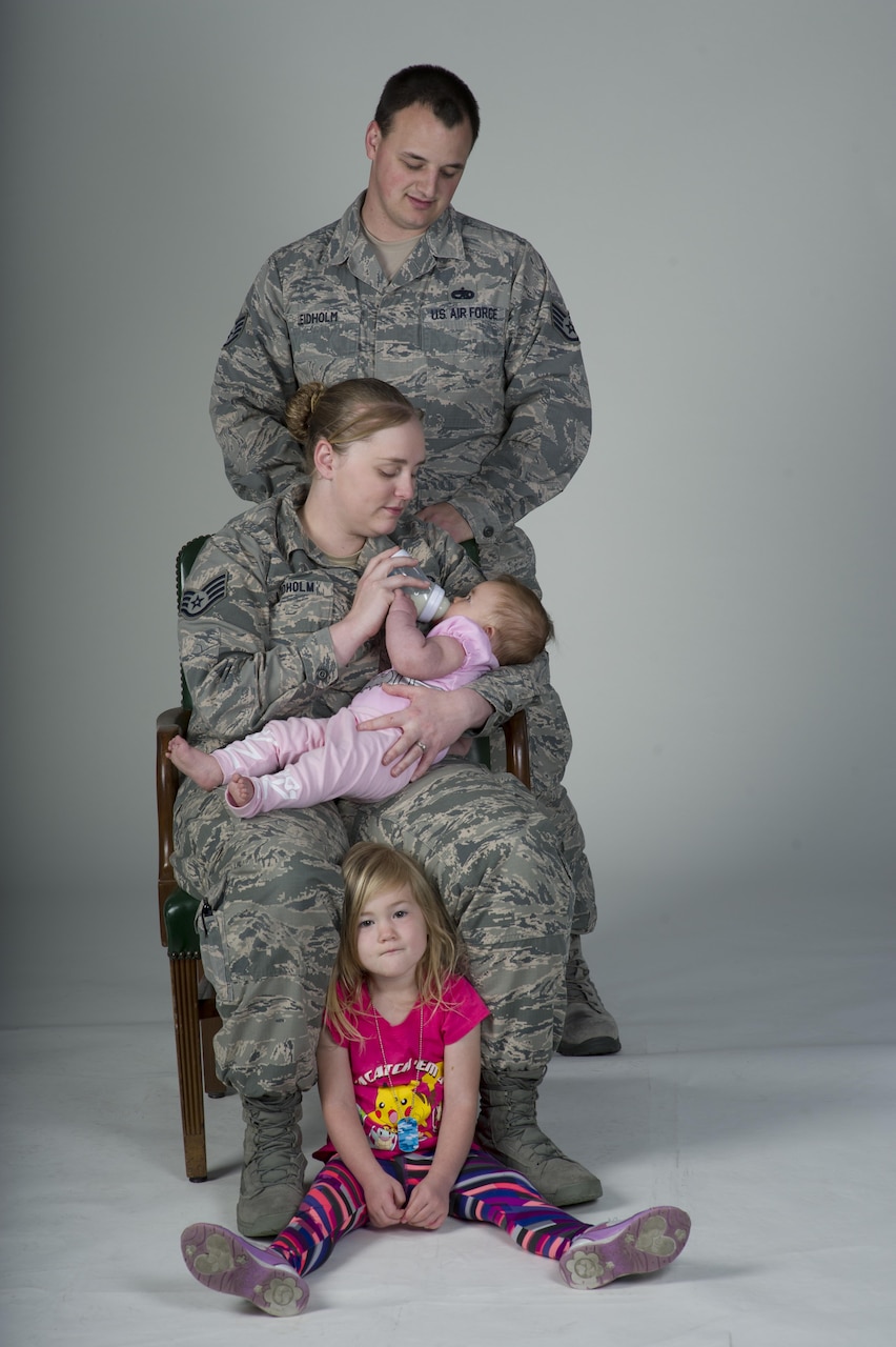 U. S. Air Force family, Staff Sgt. Kyle Leidholm, 60th Aircraft Maintenance Squadron, and SSgt. Nicole Leidholm, 60th Air Mobility Wing Public Affairs, deal with the challenges that every dual-military couple faces on a day to day basis, take time for a family portrait, Apr. 6, 2017, Travis Air Force Base, Calif. (U.S. Air Force photo/ Heide Couch)