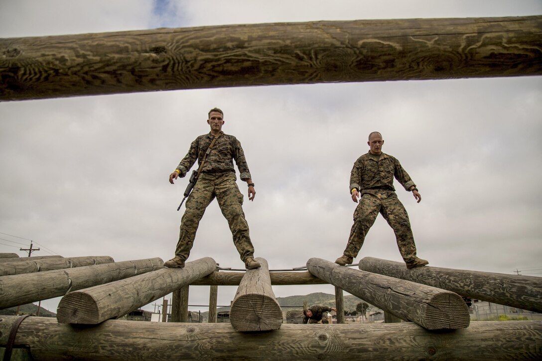 Marine Corps Capt. Cameron Heard, left, and Staff Sgt. Michael Birch  walk on logs during the inaugural Challenge Reconnaissance at Camp Pendleton, Calif., April 27, 2017. The challenge comprises 24 miles of hiking, helocasting, scout swimming, a memory challenge, obstacle course, live-fire range, close-quarters tactics and two pool stations. Marine Corps photo by Cpl. Brandon Martinez