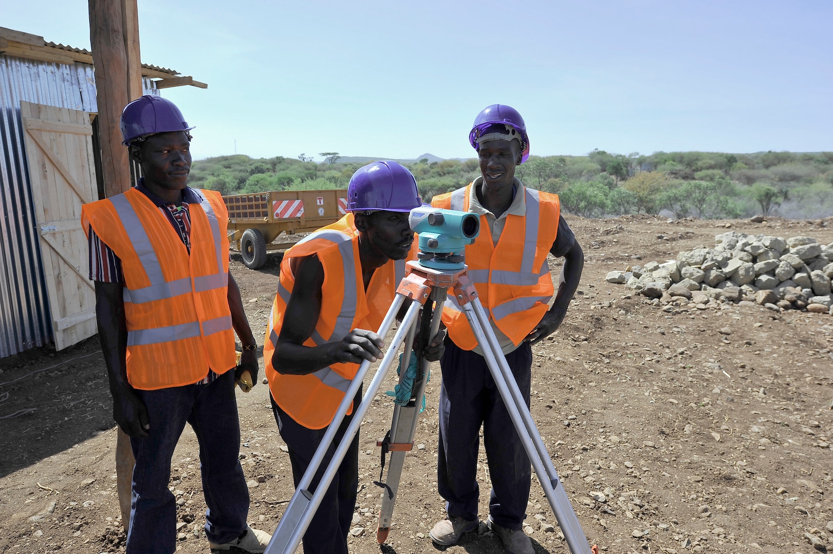 In 2014, water workers survey a biomass site in Kenya as part of the USAID Power Africa initiative.  