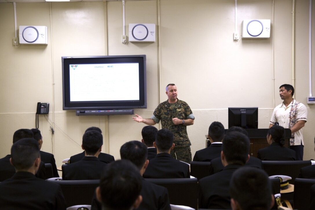 MCAS FUTENMA, OKINAWA, Japan –Lt. Col. Bob Sweginnis gives a brief to officer candidates with Japan Maritime Self-Defense Force March 24 on Marine Corps Air Station Futenma, Okinawa, Japan. The brief covered the cooperation between Marines and the Japan Self-Defense Force and the crucial role MCAS Futenma plays in the relationship. Sweginnis is the executive officer of MCAS Futenma. (U.S. Marine Corps photo by Cpl. Jessica Collins)
