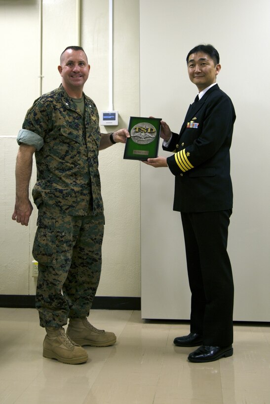 MCAS FUTENMA, OKINAWA, Japan – Lt. Col. Bob Sweginnis, left, receives a plaque from Capt. Hiroyuki Habuchi March 24 on Marine Corps Air Station Futenma, Okinawa, Japan. Officer candidates with the Japan Maritime Self-Defense Force visited the air station to learn about the cooperation between the Marines and Japan Self-Defense Force. Habuchi is the commander of the 1st Training Submarine Division, JMSDF. Sweginnis is the executive officer of MCAS Futenma. (U.S. Marine Corps photo by Cpl. Jessica Collins)